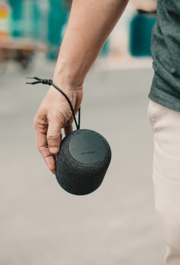 Portable Bluetooth Speaker being carried by a man