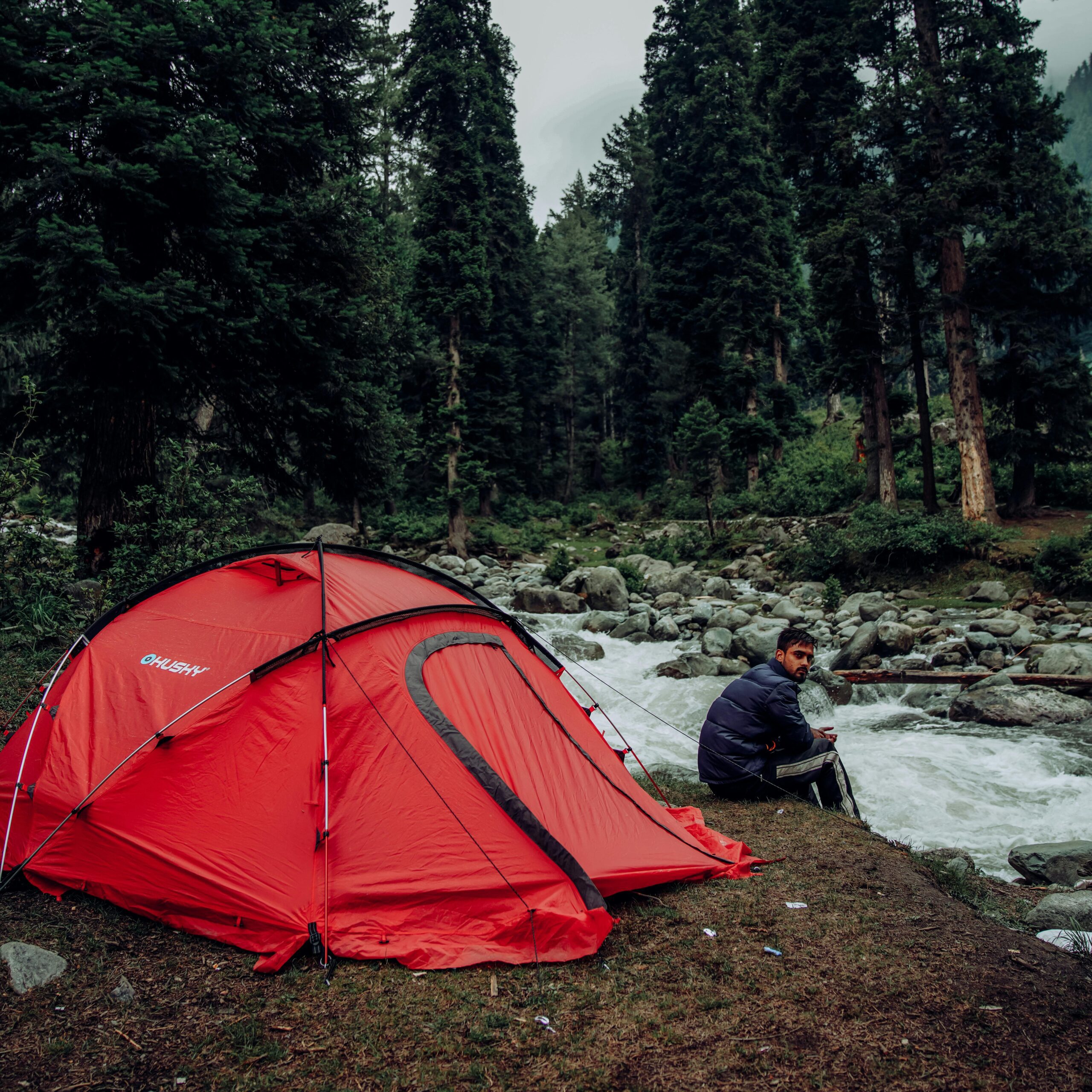 A man pondering alone while primitive camping.