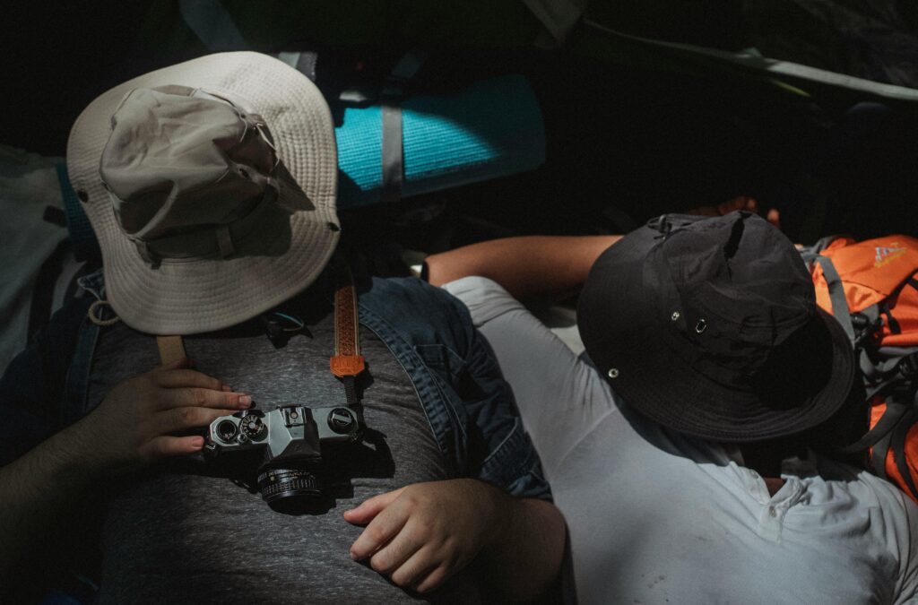 A pair of friends sleeping in a tent while primitive camping.